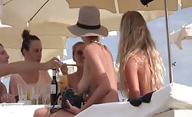 Hot babes eating topless at the beach